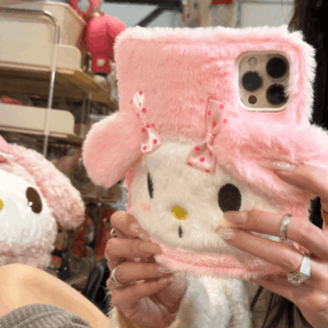 A pink plush flip iPhone case featuring the character My Melody, with a person holding the phone case to show the design and buttons.