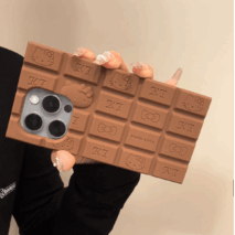A person holding a chocolate-colored silicone iPhone case featuring Rilakkuma and Hello Kitty characters.