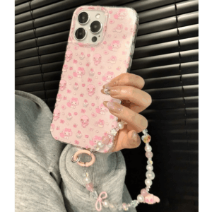 A person holding a pink iPhone case featuring My Melody and My Sweet Piano characters with a matching lanyard.