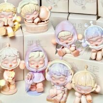 Collection of Pop Mart Skullpanda small figurines with pastel colors and soft features on a white background.